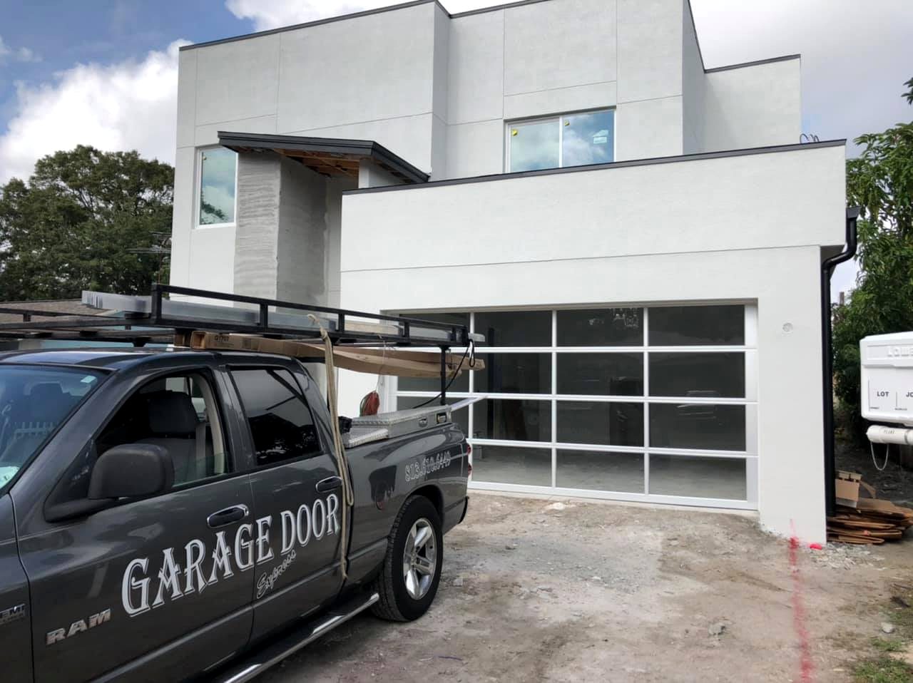 Garage door project with service truck and modern glass door