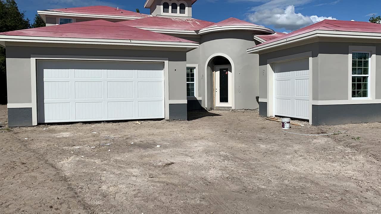 Two white garage doors on home exterior